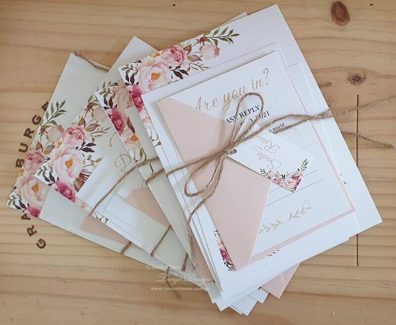 blush floral wedding invitation set with rustic twine.