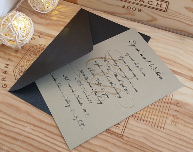 Simple wedding invitations. Gold pearlescent card and black envelope.