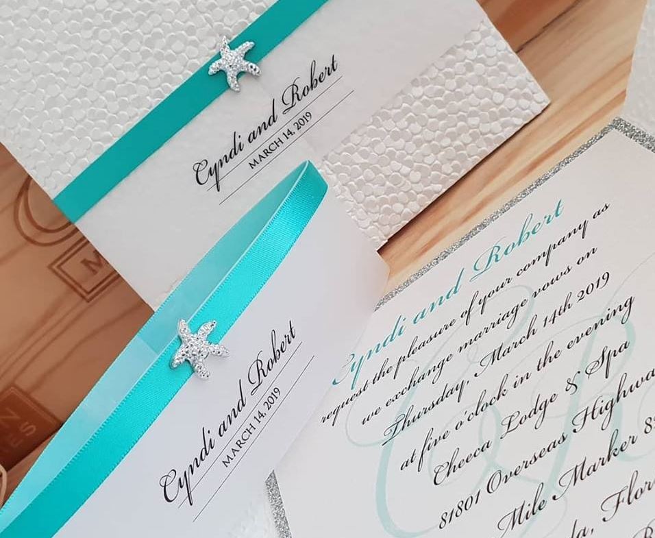 Beach wedding invitation for elegant destination wedding, with turquoise ribbon and bling starfish